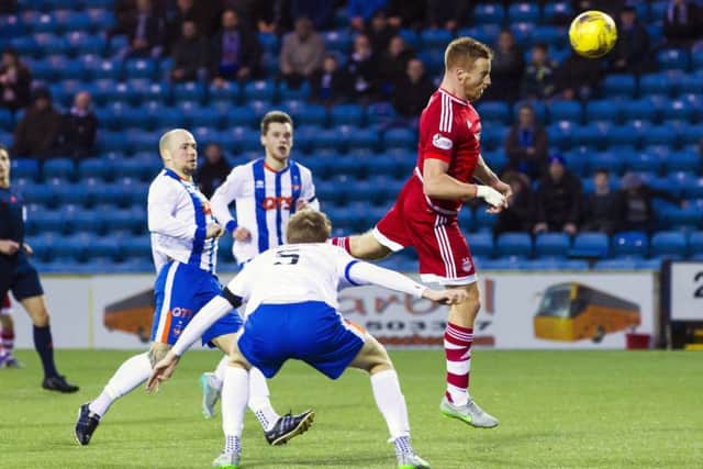 Aberdeen's Adam Rooney heads home the second goal in the Dons' 4-0 win over Kilmarnock. Picture: Roddy Scott/SNS