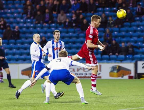 Aberdeen's Adam Rooney heads home the second goal in the Dons' 4-0 win over Kilmarnock. Picture: Roddy Scott/SNS