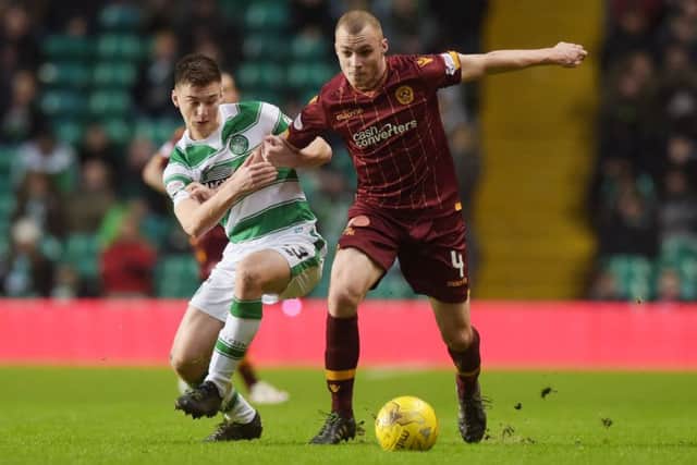 Celtic's Kieran Tierney, left, battles Motherwell's Liam Grimshaw. Picture: SNS
