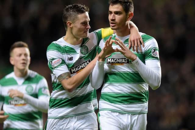 Celtic's Nir Bitton, right, celebrates with Mikael Lustig after opening the scoring against Motherwell. Picture: SNS