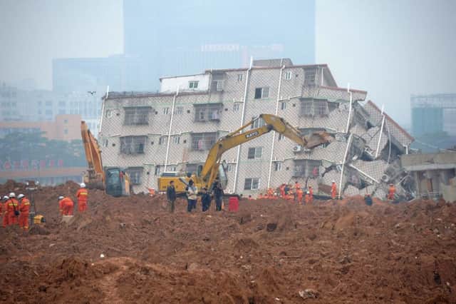 A digger sits on top of the landslide which engulfed at least 85 people. Picture: AFP/Getty