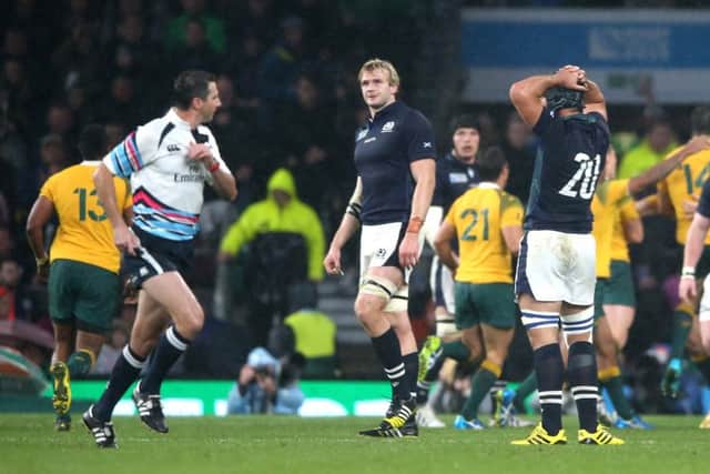 Craig Joubert, left, sprints off the pitch after the final whistle as Scotland are defeated by Australia. Picture: Getty Images