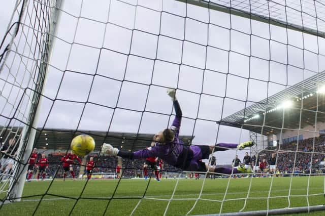 Danny Rogers saving the injury-time penalty in the game of the day. Picture: SNS