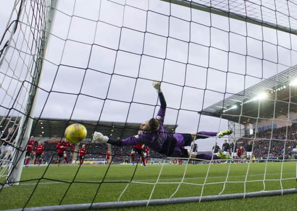 Danny Rogers saving the injury-time penalty in the game of the day. Picture: SNS