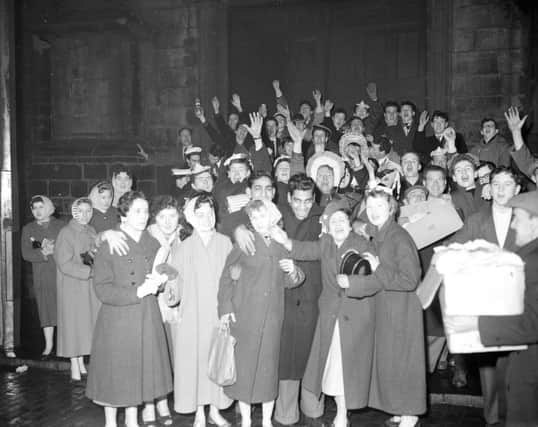 Hogmanay 1959: Revellers see in the new year outside the Tron Kirk, the traditional venue for the bells. Picture: TSPL