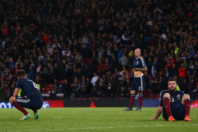 Dejected Scotland players look on after Robert Lewandowski of Poland scores with the final kick of the game to level at 2-2 at Hampden Park. Picture: Mark Runnacles/Getty Images)