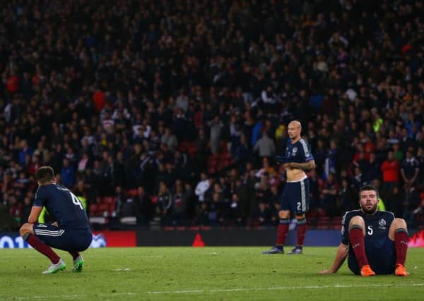 Dejected Scotland players look on after Robert Lewandowski of Poland scores with the final kick of the game to level at 2-2 at Hampden Park. Picture: Mark Runnacles/Getty Images)