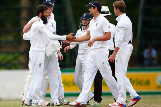 Moeen Ali is congratulated by captain Alastair Cook after his fifth wicket  in a haul of six for 77  in Petermartizburg yesterday. Picture: Getty