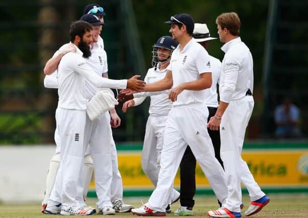 Moeen Ali is congratulated by captain Alastair Cook after his fifth wicket  in a haul of six for 77  in Petermartizburg yesterday. Picture: Getty