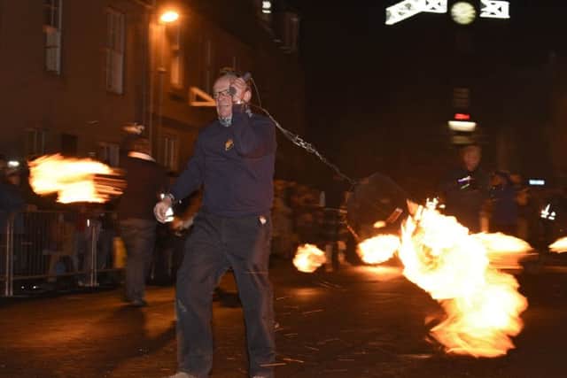 Stonehaven's Open Air In The Square Hogmanay celebrations sees fireball carriers put on a display that echoes Viking traditions. Image:  
Andy Thompson.