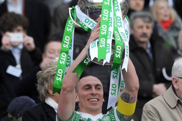 Scott Brown holds aloft the Scottish League Cup last season, but has his eyes on a clean sweep of trophies this campaign. Picture: Lisa Ferguson