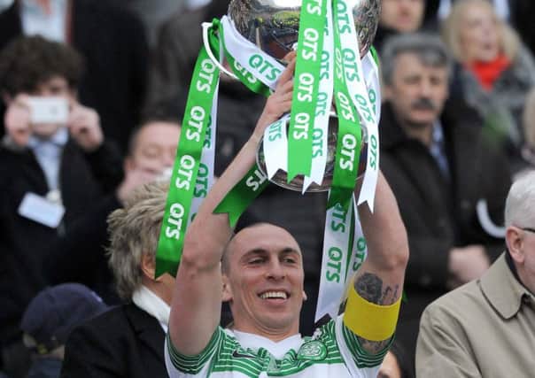 Scott Brown holds aloft the Scottish League Cup last season, but has his eyes on a clean sweep of trophies this campaign. Picture: Lisa Ferguson