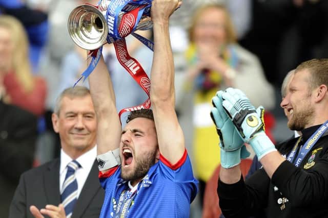 Graeme Shinnie holds the Scottish Cup aloft after Invernesss 2-1 final win over Falkirk at Hampden. Picture: Michael Gillen