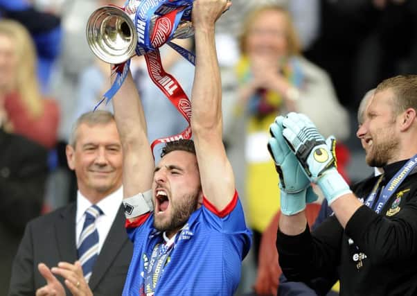 Graeme Shinnie holds the Scottish Cup aloft after Invernesss 2-1 final win over Falkirk at Hampden. Picture: Michael Gillen