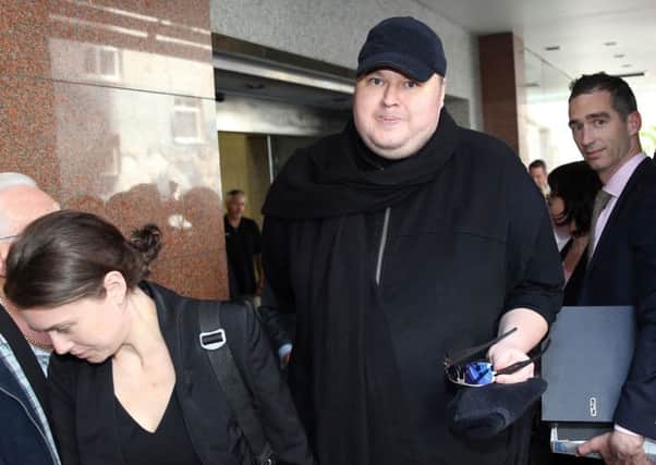 Kim Dotcom leaves court after hearing the  extradition decision. Picture: Getty