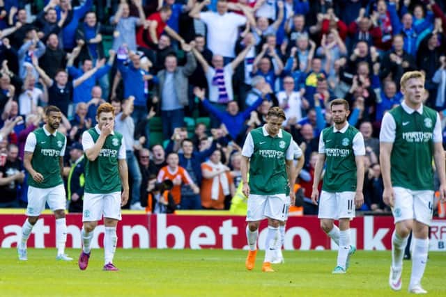 Hibernian players stand dejected after the 6-2 defeat by Rangers in the Petrofac Training Cup. Picture: Alan Harvey/SNS