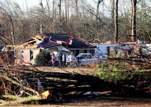 Residents assess the tornado damage in Mississippi. Picture: AP