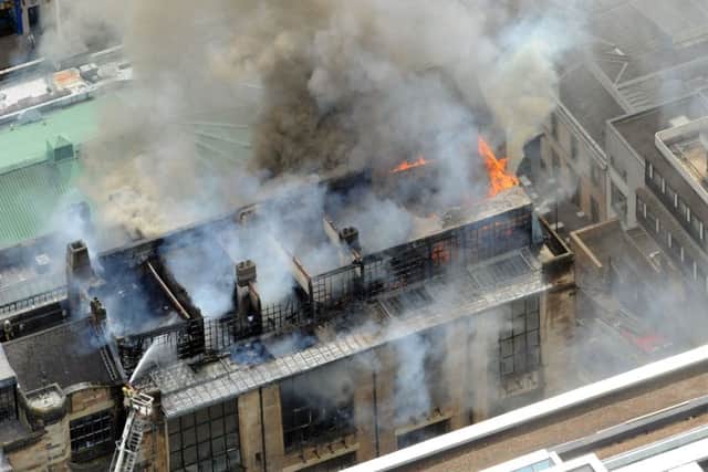 Firefighters douse the flames at the Mackintosh building. Picture Paul Chappells
