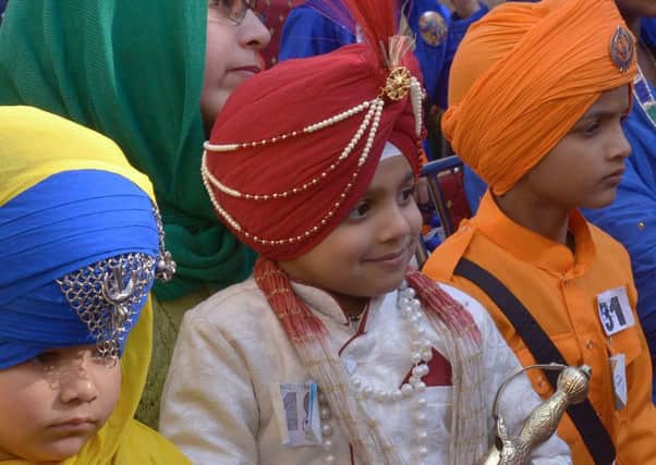 Young Indian Sikhs wait for the judging of a turban tying competition at a school in Amritsar. Picture: Getty Images