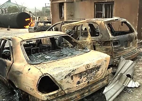 A burning cistern and burnt cars in the aftermath of a blast at an industrial gas plant in Nnewi, southeastern Nigeria. Picture: AP