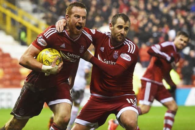 Adam Rooney wheels away after scoring a late penalty to earn Aberdeen a point against Inverness Caledonian Thistle. Picture: SNS Group
