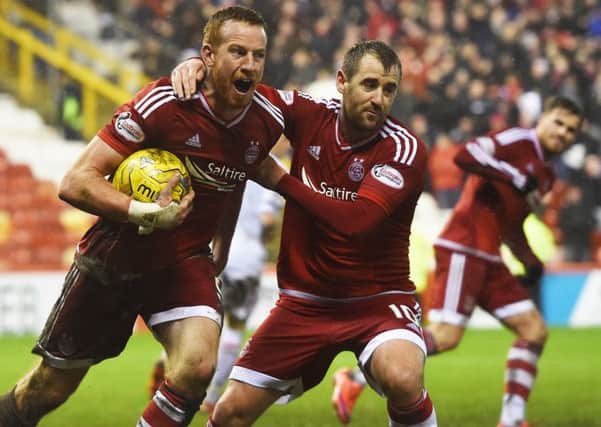 Adam Rooney wheels away after scoring a late penalty to earn Aberdeen a point against Inverness Caledonian Thistle. Picture: SNS Group