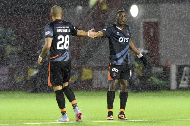 Josh Magennis congratulates Tope Odabeyi after he scored the only goal of the game at a rain-lashed New Douglas Park. Picture: SNS Group