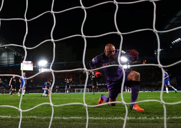 Watford 'keeper Heurelho Gomes celebrates as a dejected Oscar sinks to his knees in the background. Picture: Getty Images