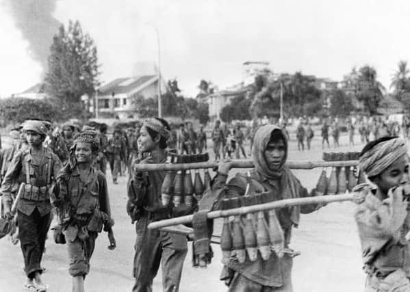 Khmer Rouge guerrilla soldiers carry mortars into Cambodian capital Phnom Penh. Picture: Getty