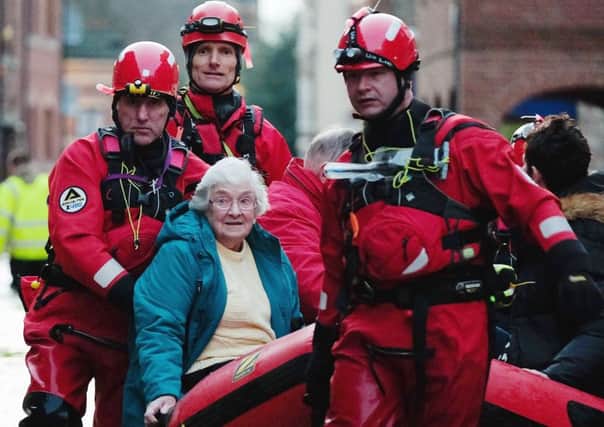 Members of Cleveland Mountain Rescue and soldiers assist members of the public as they are evacuated from the a hotel in York. Picture: Getty
