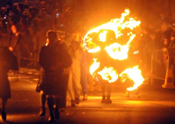 The annual Hogmany fireball swiniging parade in Stonehaven make their way down the High Street