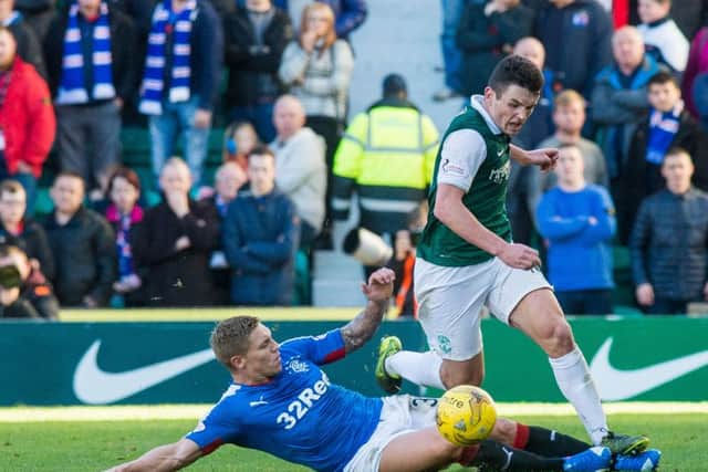 Martyn Waghorn attempts to stop John McGinn in the last meeting between Hibs and Rangers. Picture: Ian Georgeson