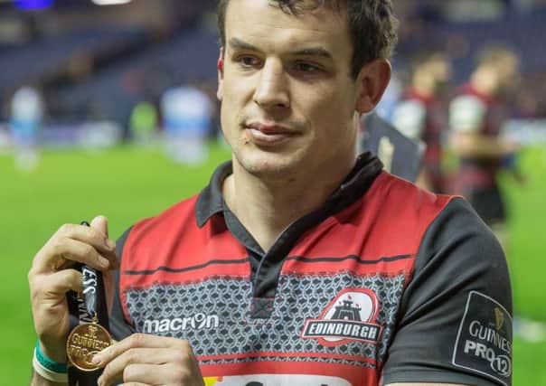 John Hardie shows off his man of the match medal on Sunday. Picture: Neil Bain