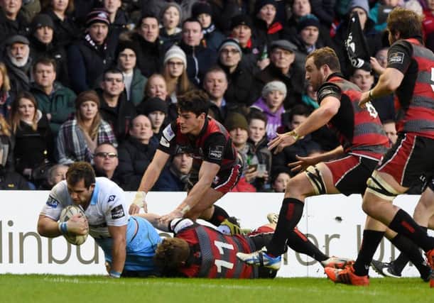 Fraser Brown holds off the attentions of Edinburgh pair Sam Hidalgo-Clyne and Tom Brown (No 11). Picture: SNS