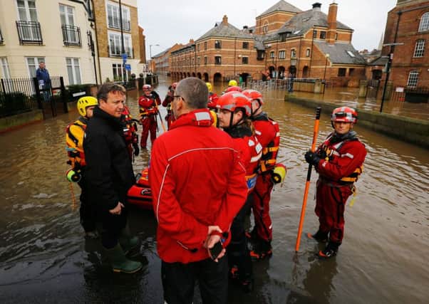 David Cameron meets flood relief workers in York after the river Ouse burst its banks. Picture: AFP/Getty Images