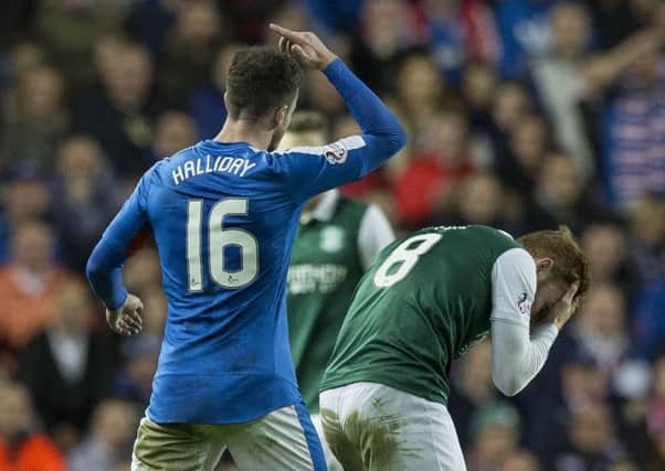 Rangers midfielder Andy Halliday was shown a red card after this incident with Hibs' Fraser Fyvie. Picture: Alan Rennie