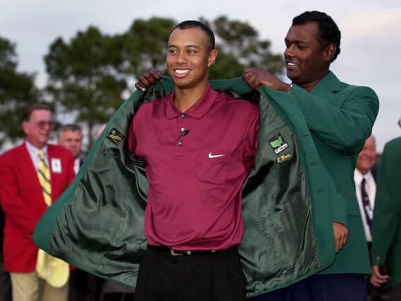 Tiger Woods is presented with his second green jacket at Augusta in 2001. Picture: Harry How/Allsport