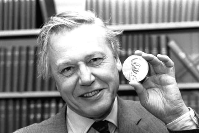 British journalist and broadcaster Sir David Attenborough with the Livingstone medal he received at a Royal Geographical Society lecture in Edinburgh, March 1990.