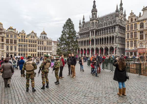 Belgian soldiers patrol as tourists visit the Grand Place in Brussels. Picture: AP