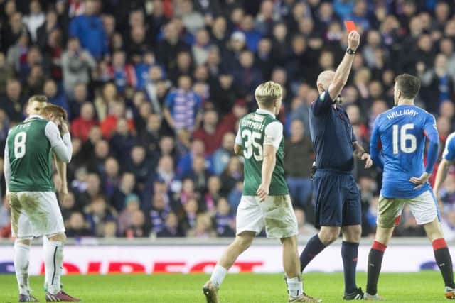 Fraser Fyvie, left, holds his head as Rangers' Andy Halliday is sent off. Picture: Jeff Holmes/PA Wire