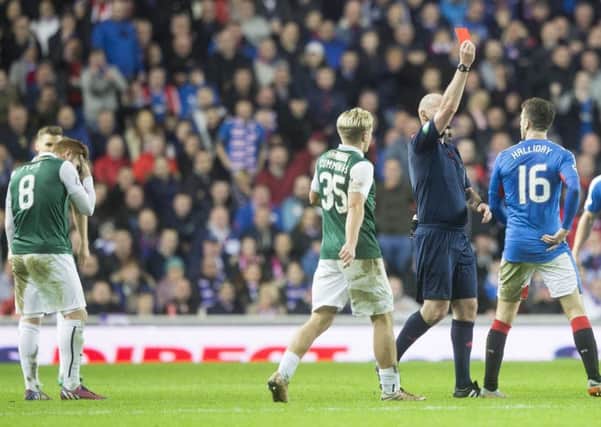 Fraser Fyvie, left, holds his head as Rangers' Andy Halliday is sent off. Picture: Jeff Holmes/PA Wire
