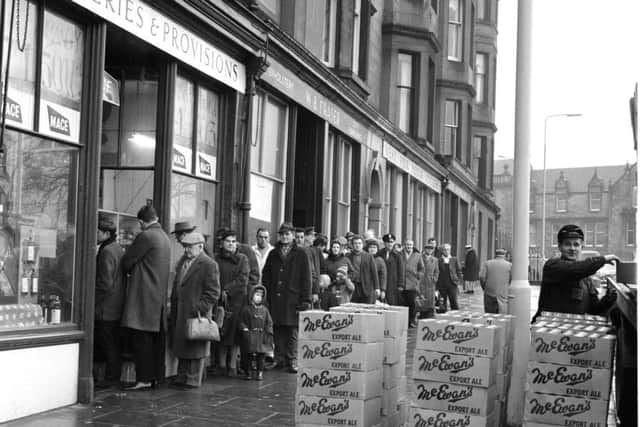 Customers queue outside Mr Munro's shop at Brandon Terrace in Edinburgh stocking up for Hogmanay.