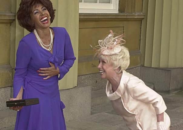 Barbara Windsor with Shirley Bassey in 2000 when she received her MBE at the Palace as Bassey became a Dame. Picture: PA