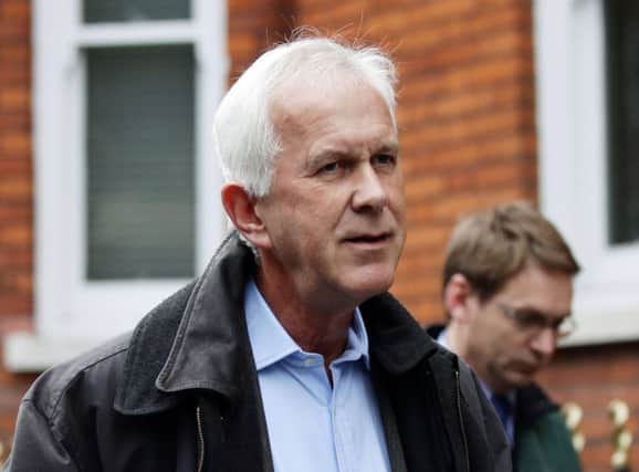 A tanned Sir Philip Dilley leaves his London flat yesterday. Picture: PA