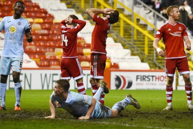 Agony for Aberdeen players Cammy Smith, Graeme Shinnie and Adam Rooney as a chance goes abegging at Pittodrie last night. Picture: SNS