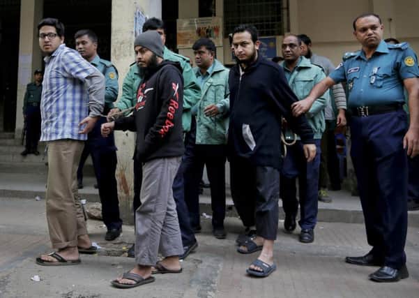 Policemen escort three men accused of killing Ahmed Rajib Haider, inset,  to a court in Dhaka yesterday. Picture: AP