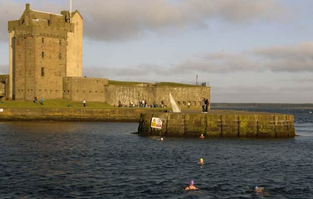 Members of The Ye Amphibious Ancients Bathing Association swim in the harbour beside Broughty Ferry