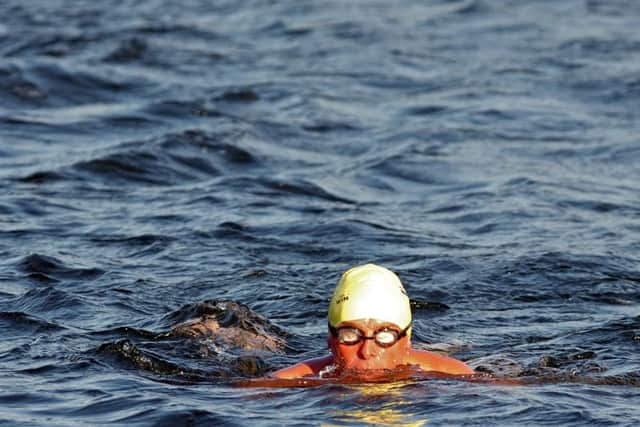 Members of The Ye Amphibious Ancients Bathing Association swim in the harbour beside Broughty Ferry