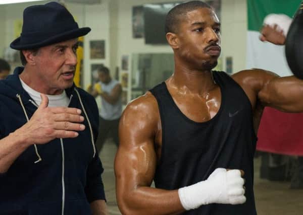 Sylvester Stallone as Rocky Balboa and Michael B Jordan as Adonis Creed in Creed
