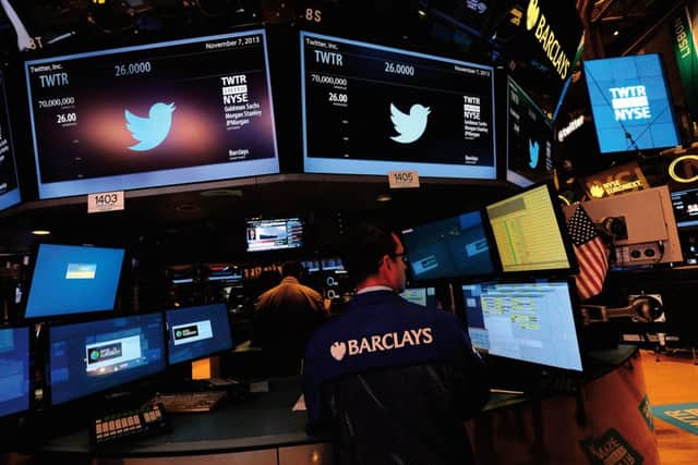 Traders are shown with the logo of Twitter and the symbol on which Twitter's stock will be traded (TWTR) on the floor of the New York Stock Exchange (NYSE). Picture: Getty Images